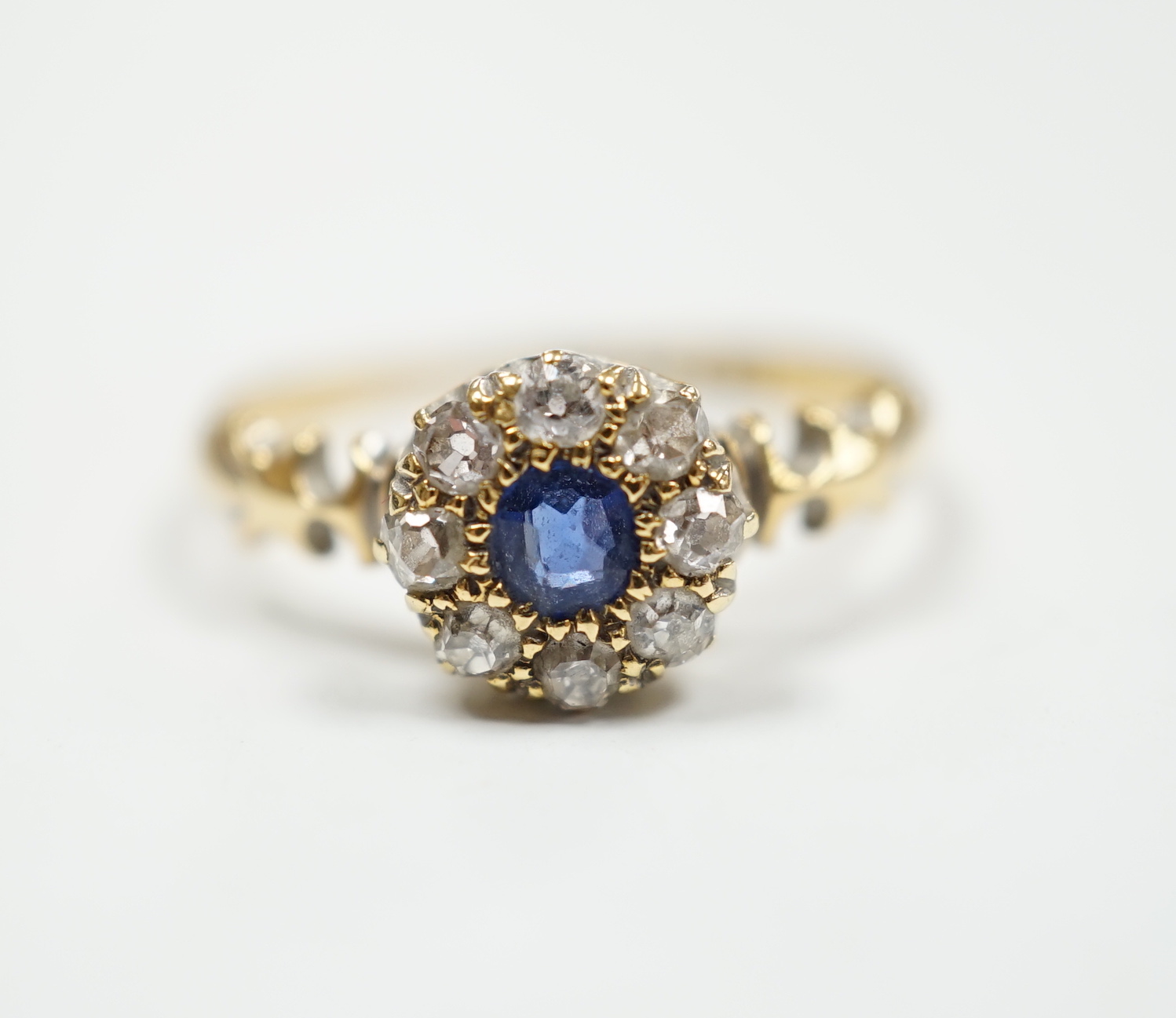 A late Victorian 18ct gold, sapphire and diamond set circular cluster ring, Birmingham, 1889, size M, gross weight 2.7 grams.